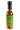 A bottle of Smokin' Ed's Taco - Pepper X sauce with a green and orange flame label, chile peppers logo, five-pepper heat indicator, and a black cap.
