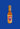 A bottle of Colorful Colorado Creations - Black Garlic Buffalo sauce with a gold cap, a label showing a red C, mountain graphic, and "Colorful Colorado Creations" on blue—ideal for fans of bold cayenne pepper flavor.