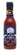 A bottle of Mikey V's Ghostly Garlic hot sauce features a large skull label with spider webs and bold red and white text. Inside is a deep reddish-brown sauce blending roasted garlic and smoked ghost peppers for a haunting flavor.