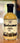A 16 fl oz (473 ml) bottle of Smokin' Ed's Herbaceous Salad Dressing, featuring cream-colored, spicy dressing. The label has decorative text and black flame graphics at the bottom.