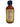 A 2 oz mini bottle of Smokin' Ed's Honey Bonnet hot sauce with a black cap, featuring a yellow nutrition facts label and ingredients list on the back, is showcased against a plain white background.