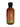 Smokin' Ed's Smokin' Sriracha 2 oz Mini Bottle features a black cap, red label with green accents, and nutrition facts on the back. This medium heat hot sauce is perfect for adding bold flavor to any meal.