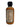 A 2 oz mini bottle of Smokin' Ed's Voodoo Prince Death Mamba with a black cap displays the nutrition facts label on the back. The orange-brown ghost pepper hot sauce inside signals its spicy heat, all set against a white background.