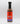 A bottle of Smokin' Ed's British Brown - Mild sauce with a black cap, red and blue label, flames graphic, and “Mild British Brown Sauce” text. This mild condiment offers unique flavors against a white background.