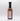 A glass bottle of Smokin' Ed's British Brown - Mild sauce with a black cap displays its nutrition and ingredients label on the back, featuring this mild condiment’s unique flavors against a white background.
