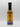 A bottle of Smokin' Ed's Currie Churri - Pepper X Edition hot sauce with an orange and blue label, flame graphics, and a circular top logo promises fiery heat from its bold spices, shown against a plain white background.