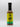 A bottle of Smokin' Ed's Jerk - Pepper X Edition, featuring a yellow and green label, black cap, lion logo, and flame graphics at the bottom, is set against a white background for a bold and spicy touch.