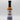 A bottle of Smokin' Ed's Korean Dumpling - Mild sauce, an orange-red mild chili sauce for Korean cuisine, featuring a black cap, white label with blue flames, and a logo above the product name.