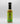 A bottle of Smokin' Ed's Mustard Dill - Pepper X Edition hot sauce, with a black cap and green label featuring flame graphics and branding, is displayed on a plain white background.