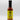 A bottle of Smokin' Ed's Pineapple Teriyaki - Mild hot sauce, featuring a yellow label, black cap, and flame graphics at the bottom, stands upright on a white background.