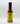 A bottle of Smokin' Ed's Pineapple Teriyaki - Mild hot sauce, featuring a yellow label, black cap, and flame graphics at the bottom, stands upright on a white background.