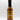 A bottle of Smokin' Ed's Sazon - Pepper X with a black cap, orange label, and flame graphics at the bottom stands upright against a plain white background.