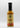 A bottle of Smokin' Ed's Shawarma - Hot sauce with a black cap. The label shows flames at the bottom, bold "Shawarma - Hot" text, garlic and chili accents, a top logo, and a 5-flame heat rating.