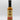A bottle of Smokin' Ed's Shawarma - Mild sauce with a black cap and a cream-colored label featuring red flames, text, and logo at the top. Infused with garlic and chili powder, it stands on a white surface against a plain background.