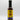 A bottle of Smokin' Ed's Spicy Malt Vinegar - Mild with a yellow label, black cap, and blue flames at the bottom, showcasing its bold blend of mild spicy malt vinegar and chili powder, set against a plain white background.