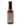 A bottle of Smokin' Ed's Tamarind - Mild chile pepper sauce with a black cap displays its nutrition facts and ingredients label on the back. The red-orange sauce is set against a plain white background.