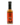 A bottle of Smokin’ Ed’s Wing Thing - Mild, a smoky reddish-brown hot wing sauce with an orange label featuring black flames and the Smokin’ Ed’s logo, topped with a black cap.