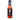 A bottle of Wicked Provisions Wicked Original Hot Sauce has a black label with a skull and crossed utensils, highlighting red Fresno peppers and garlic. The bright red sauce stands out against the white background.