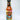 A bottle of Mikey V's E.A.F.O. hot sauce, made with Carolina Reaper Peppers, displays a vibrant illustrated label with bold text and fiery graphics, standing upright against a plain white background.