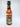 A bottle of Mikey V's E.A.F.O. hot sauce, made with Carolina Reaper Peppers, displays a vibrant illustrated label with bold text and fiery graphics, standing upright against a plain white background.