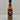 Mikey V's Texas Ex's Hot Sauce comes in a black-labeled bottle with red and green chili peppers, the Texas flag, and bold red/yellow text. This spicy sauce features lively flavor with a touch of ghost pepper heat.