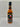 Mikey V's Texas Ex's Hot Sauce comes in a black-labeled bottle with red and green chili peppers, the Texas flag, and bold red/yellow text. This spicy sauce features lively flavor with a touch of ghost pepper heat.
