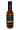 A bottle of AKA Miso Ghost-Reaper Hot Sauce with a black label featuring chili art and spice icons. Made with miso and ghost pepper, this Hot Ones sauce is extremely spicy, vegan, and gluten-free.