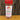 A 4 oz. White Wolf Rubs Hunter Rub jar with a red lid rests on wood against tree bark. This spicy rub is perfect as a hunter seasoning or dry rub for chicken wings, beef, pork, venison, and soups.