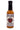 A 5 oz bottle of Bad Apple hot sauce features a red apple illustration and decorative text. This Smokin' Ed Currie creation blends sweet apple and cinnamon with reaper heat. The label shows the PuckerButt Pepper Company website.