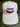 The Light Pink PuckerButt Hat features the logo and a red chili pepper embroidered on the front, with "Pure. Organic. Heat." stitched in green and red. It’s shown on a wooden surface.