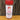 A 4-ounce jar of White Wolf Rubs Primal Rub and Seasoning rests on a wooden surface against a rustic wood background. This versatile blend enhances pork, ribs, chicken, potatoes, and veggies for delicious grilling.
