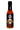 A 5 oz bottle of Rising Smoke Fiesta Caliente hot sauce, made with smoked habanero and chipotle, features a black label with a vibrant sugar skull and flames.