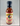 A 12 fl oz (355 ml) bottle of Mikey V's - Red Raspberry Reaper BBQ with a red and tan label showing two chili peppers, a Texas outline, and product details. This bold sauce features the heat of Carolina Reaper peppers.