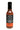 A bottle of Bravado Serrano & Basil hot sauce, with a black label, chili art, vegan and medium spice indicators—great for pizza or pasta.